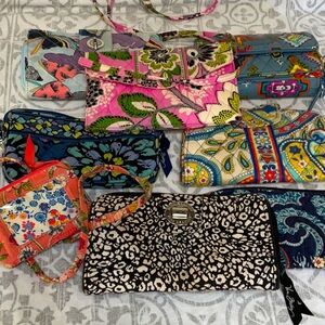 8 Vera Bradley quilted wallets and small bags.